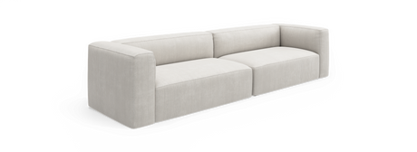 Ljusbeige modern modulsoffa med låga rundade armstöd och ribbad klädsel, visad framifrån i vinkel på svart bakgrund.