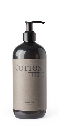 Svart pumpflaska med etiketten 'COTTON FIELD' handtvål, innehåller 500 ml.