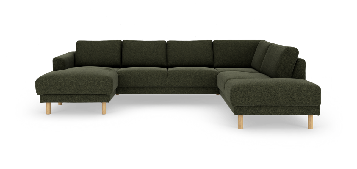 Mörkgrön U‑formad modulsoffa med schäslong till vänster och divan till höger på runda träben.