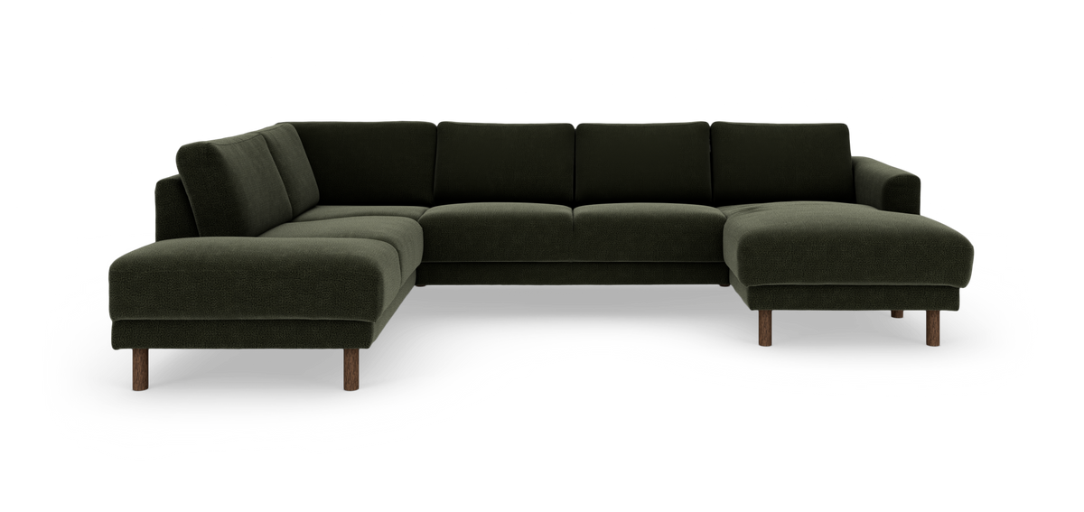 Mörkgrön modulsoffa i U‑form med divan till höger och träben.