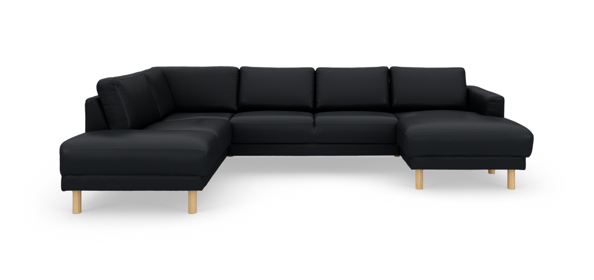 Svart modulsoffa i U‑form med schäslonger på båda sidor och ljusa runda träben.