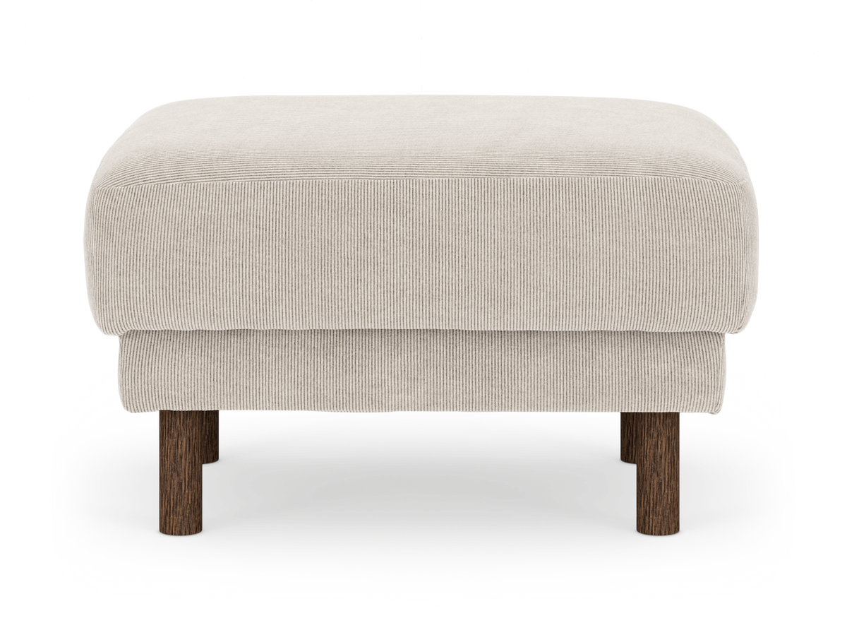 Beige fotpall i manchester med runda mörka träben.
