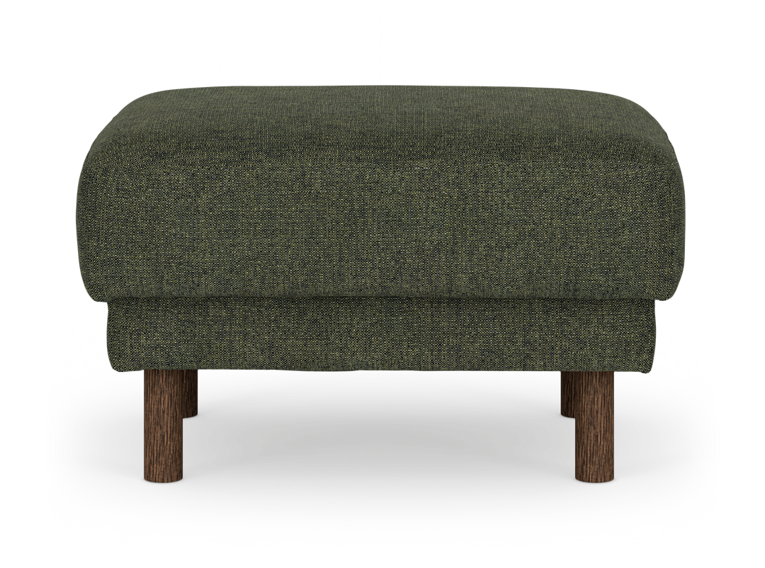 Mörkgrön tygklädd fotpall/ottoman med runda träben sedd rakt framifrån.