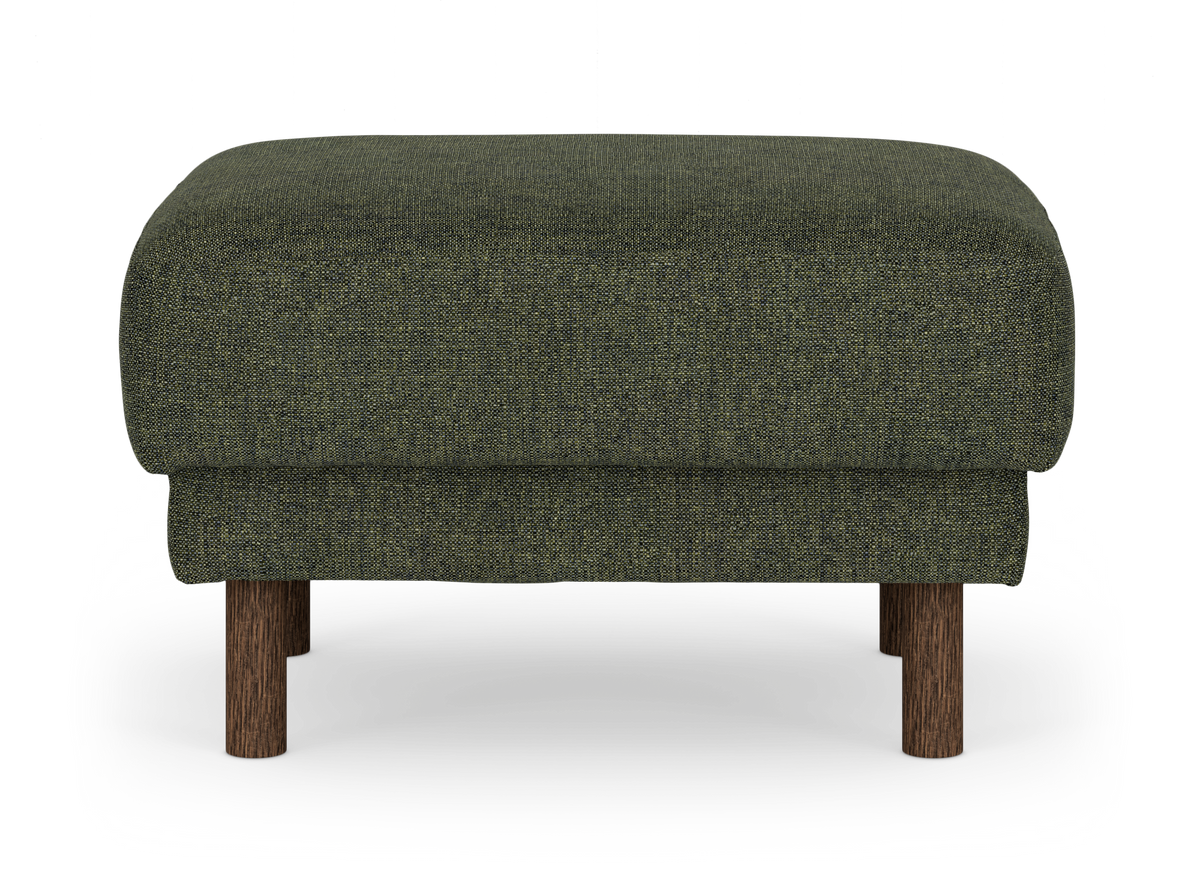 Mörkgrön tygklädd fotpall/ottoman med runda träben sedd rakt framifrån.