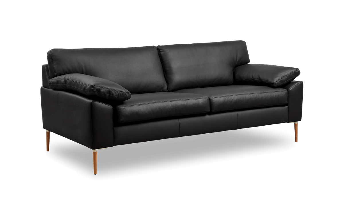 Svart lädersoffa med träben i vinklad vy.