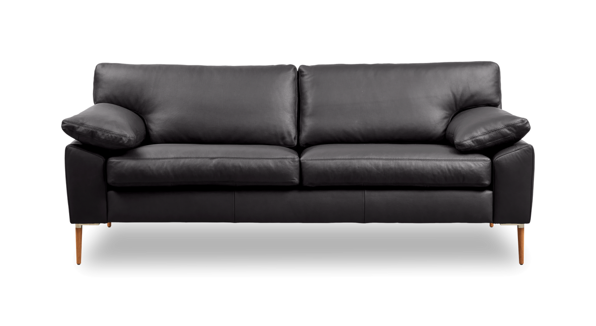 Svart lädersoffa med tre sittplatser och smala träben, sedd framifrån mot vit bakgrund.