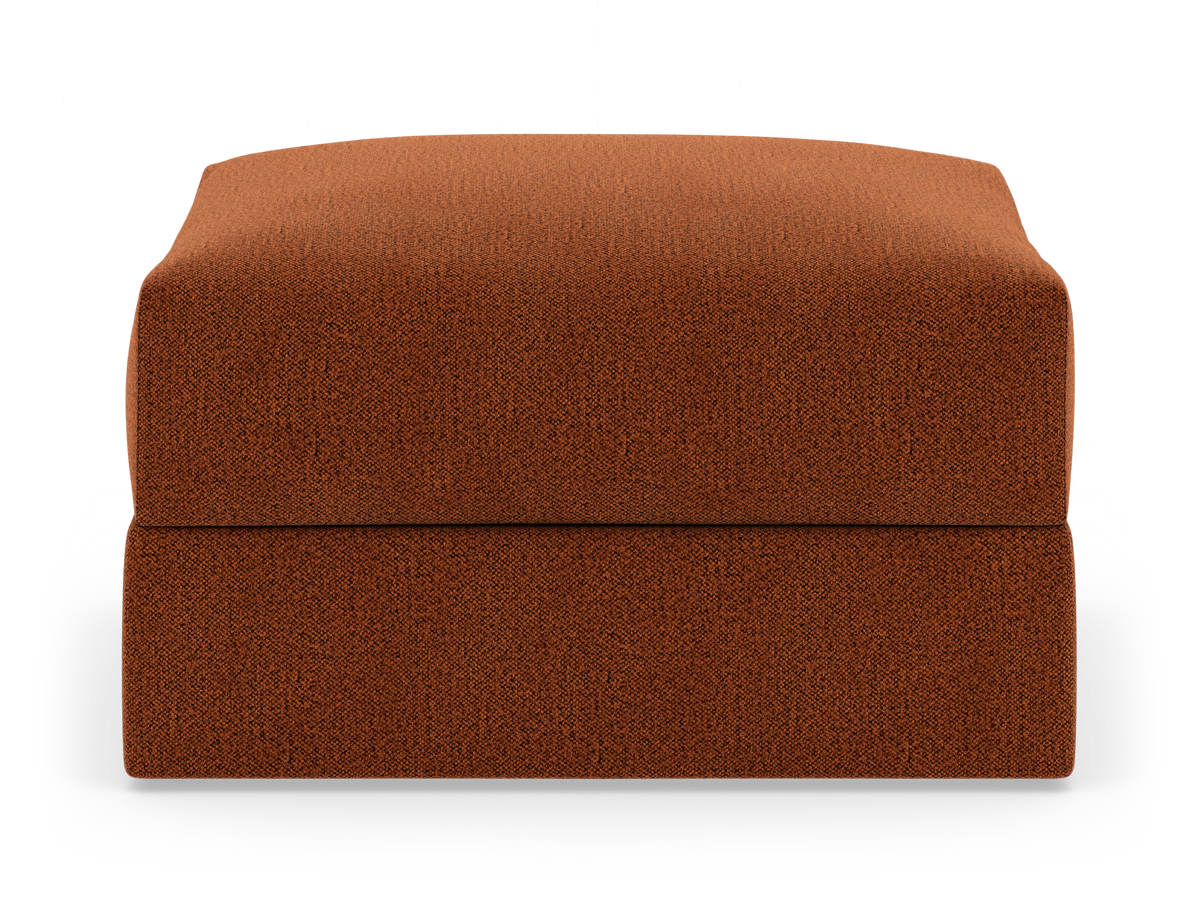 Rostfärgad, fyrkantig sittpuff/ottoman i tyg på vit studiobakgrund.