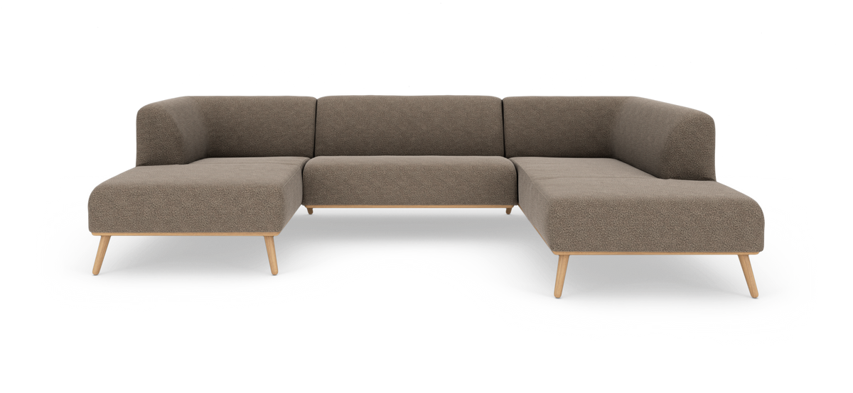 U‑formad modulsoffa i beige tyg med ben i ljust trä, frilagd på vit bakgrund.