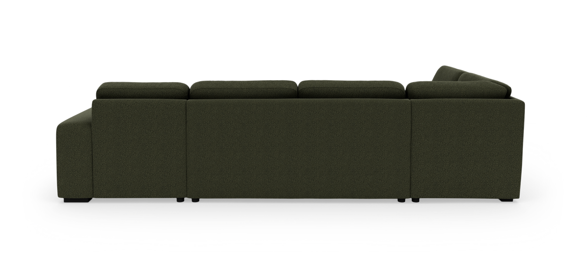 Mörkgrön modulsoffa sedd från sidan/baksidan mot vit bakgrund.
