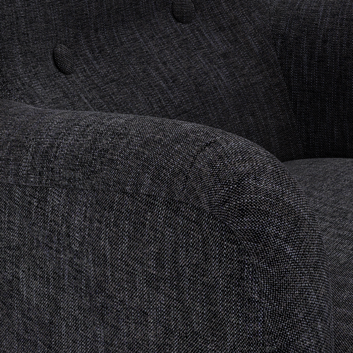 Närbild av en mörkgrå soffarm i textil med rundad form och knappar på ryggstödet.