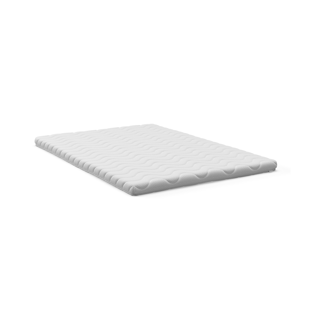 Vit bäddmadrass/topper med vågformat quiltmönster, frilagd på vit bakgrund.