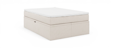 Beige klädd sängbas med vit bäddmadrass, visad i sned frontvy mot svart bakgrund.