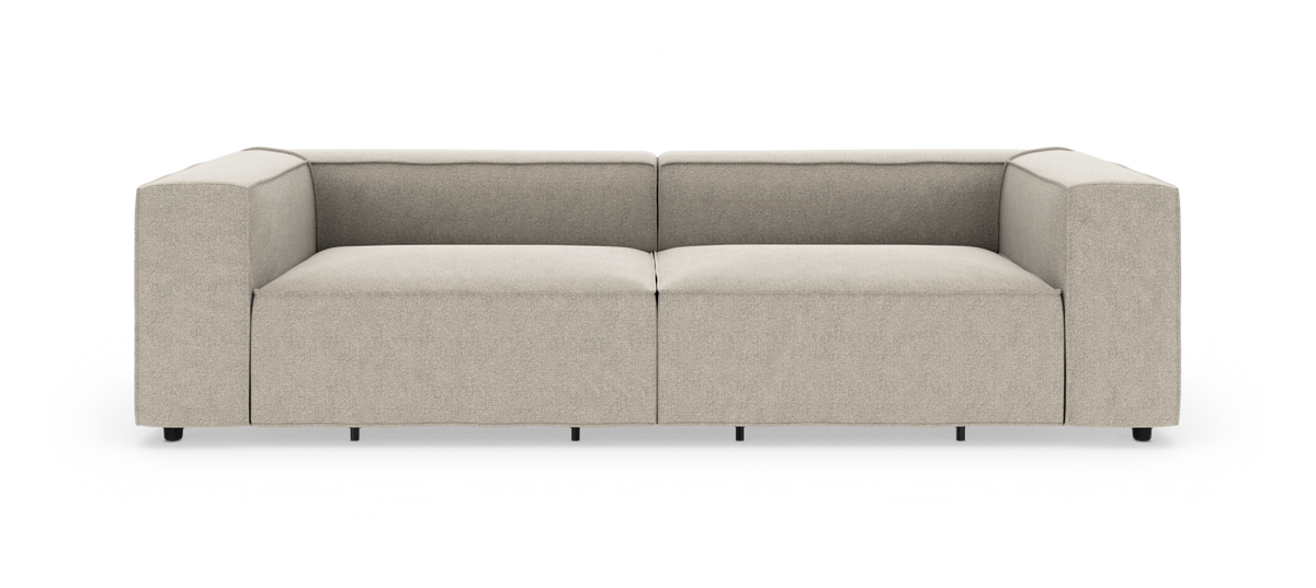 Beige modern modulsoffa med breda armstöd, frilagd mot vit bakgrund.