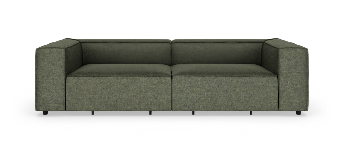 Grön modern 2‑sits modulsoffa med breda armstöd, frilagd på vit bakgrund.