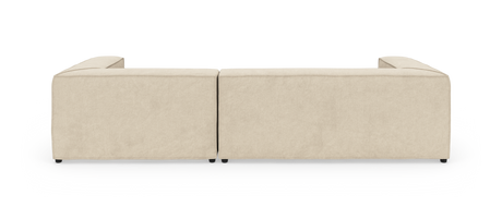 Beige modulsoffa sedd bakifrån mot vit studiobakgrund.