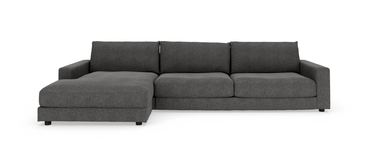 Mörkgrå modulsoffa i L‑form med vänster divan och tre ryggkuddar, modern design.