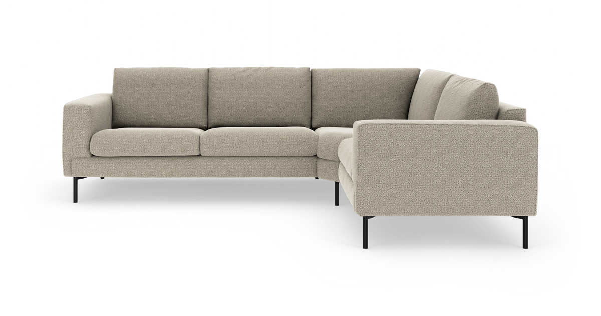 L-formad modulsoffa i beige tyg med svarta metallben och höger divan, frilagd på vit bakgrund.