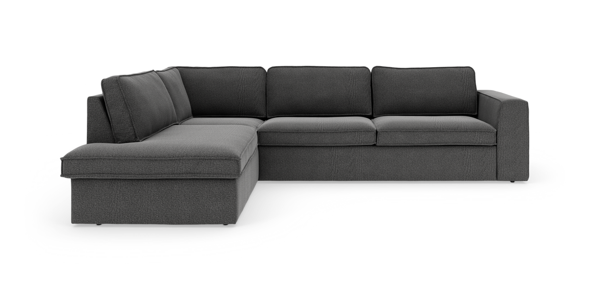 Mörkgrå hörnsoffa med schäslong till vänster i modern, rymlig design.