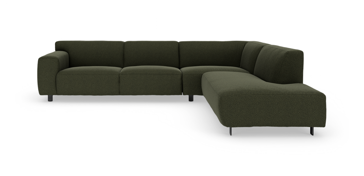 Mörkgrön L-formad modulsoffa med rundade kuddar och smala metallben, visad i studio på vit bakgrund.