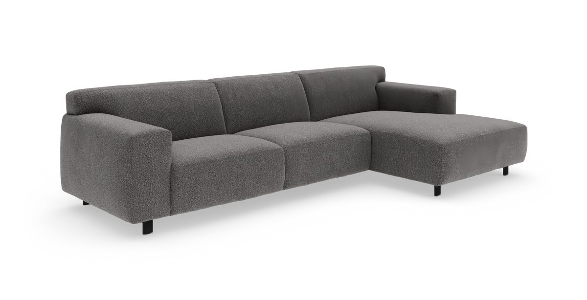 Mörkgrå modulsoffa i tyg med högerdivan, modern och låg profil.
