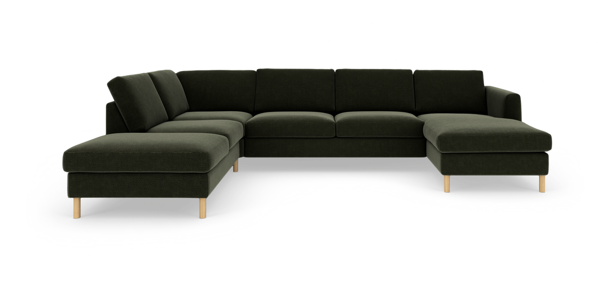 Grön modulsoffa i L‑form med schäslong och träben, frilagd på vit bakgrund.