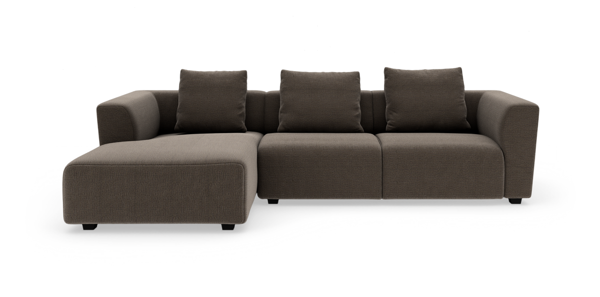 Brun modulsoffa med divan till vänster, tre ryggkuddar och rundade armstöd på vit bakgrund.