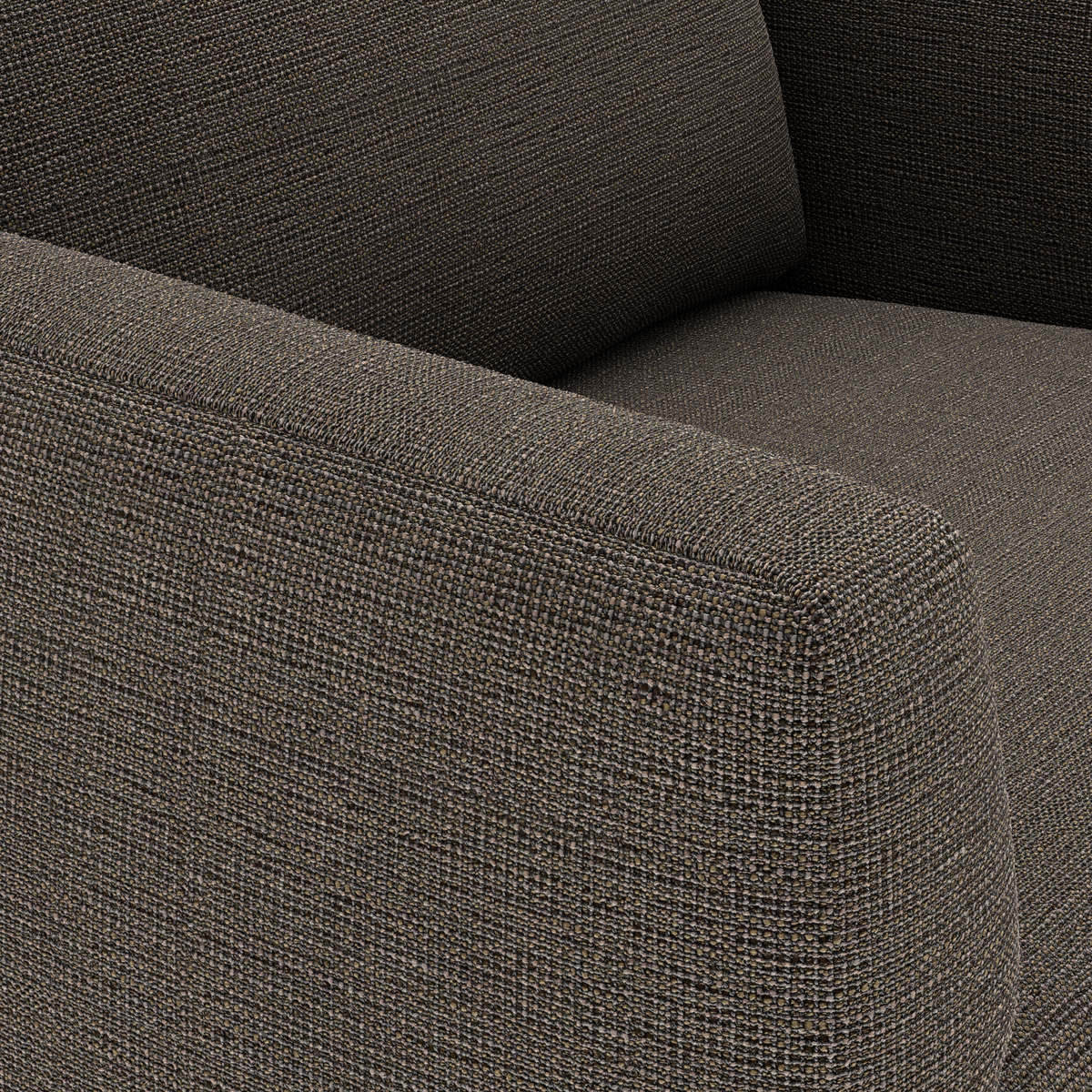 Närbild av en soffa i mörkgrå/brun textil med grovvävd struktur och armstöd.