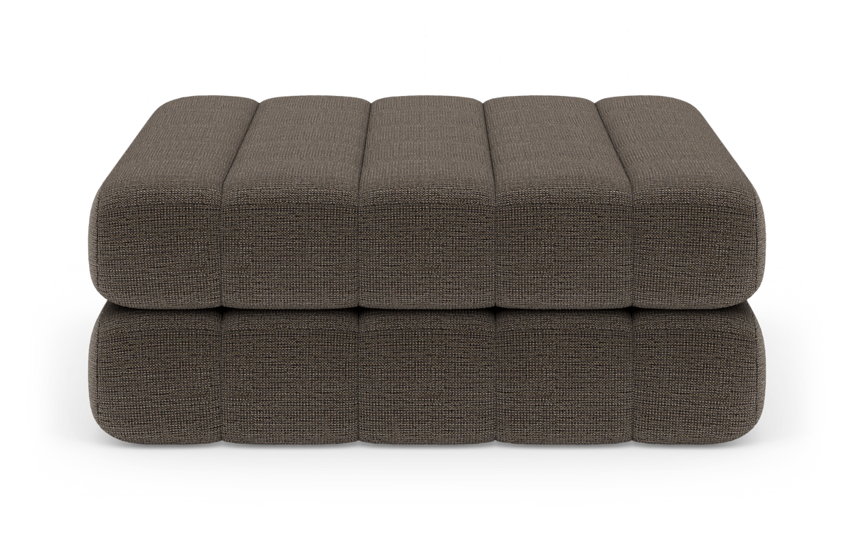 Brun, texturerad modulär ottoman/sittpuff med rundade kanter, fotograferad rakt fram i studio.