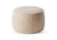 Beige rund bouclé‑puff/ottoman för sittplats eller fotpall.