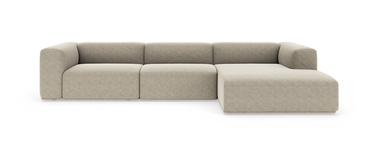 Beige modulsoffa med chaiselong till höger i modern, rundad design på vit bakgrund.