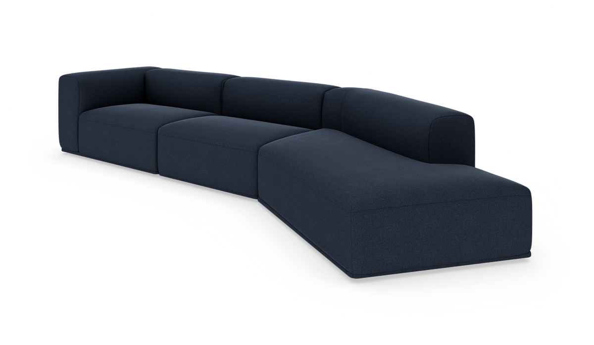 Mörkblå modulär hörnsoffa med rundade armstöd och chaise‑del, frilagd mot vit bakgrund.
