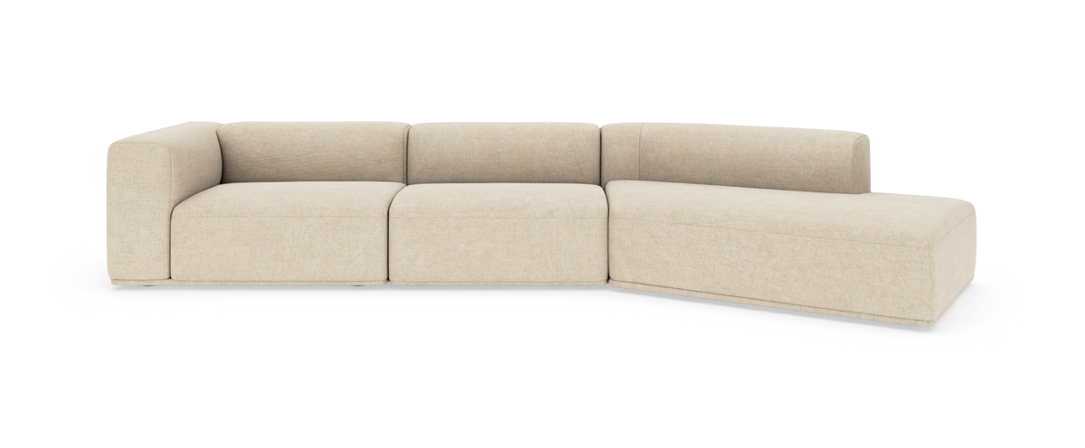 Beige modulsoffa med schäslong, mjukt rundade former och låg rygg i studiobelysning.