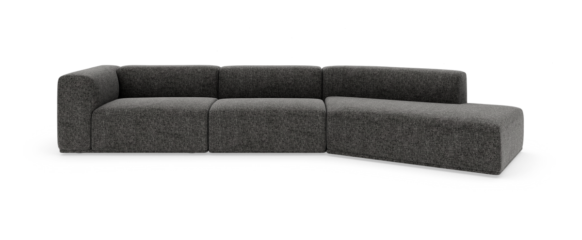 Mörkgrå modulsoffa i L‑form med mjuk, lågt byggd design, frilagd mot vit bakgrund.